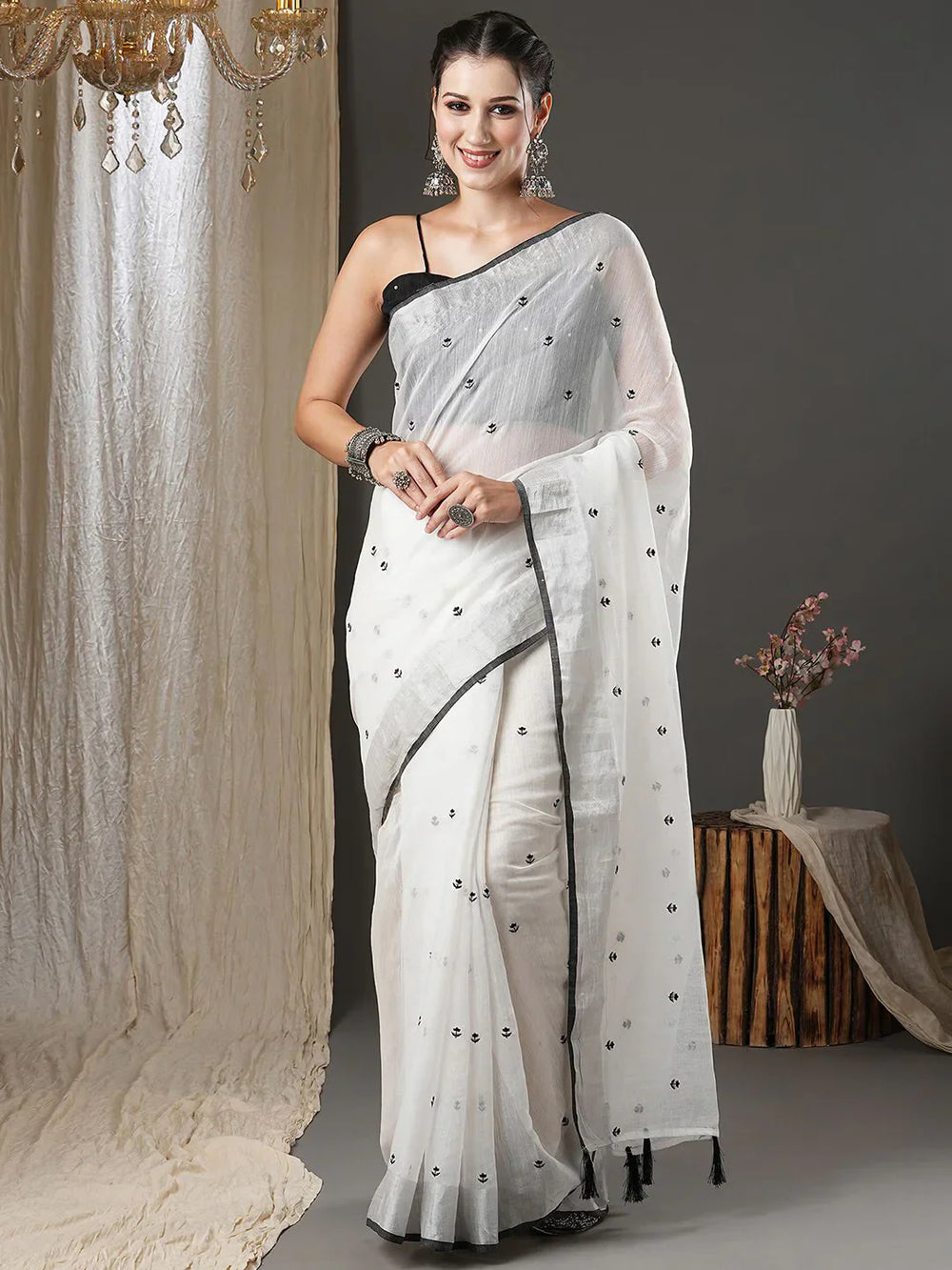 White & Black Floral Printed Zari Silk Cotton SareeSareeThis exquisite saree features a charming floral print, making it an ideal choice for festive occasions where vibrant elegance is celebrated. Adorned with intricate ZWhite & Black Floral Printed Zari Silk Cotton Saree