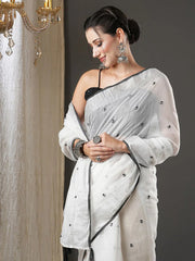 White & Black Floral Printed Zari Silk Cotton SareeSareeThis exquisite saree features a charming floral print, making it an ideal choice for festive occasions where vibrant elegance is celebrated. Adorned with intricate ZWhite & Black Floral Printed Zari Silk Cotton Saree