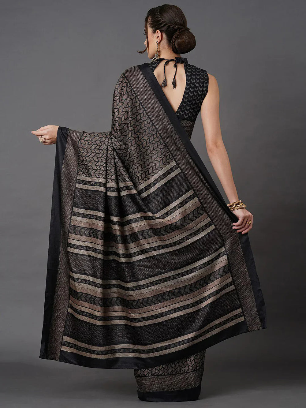 Black Printed Art Silk SareeSareeThis saree embodies festive elegance with its captivating geometric print, offering a modern twist on traditional attire. Perfect for celebratory occasions, the geomBlack Printed Art Silk Saree