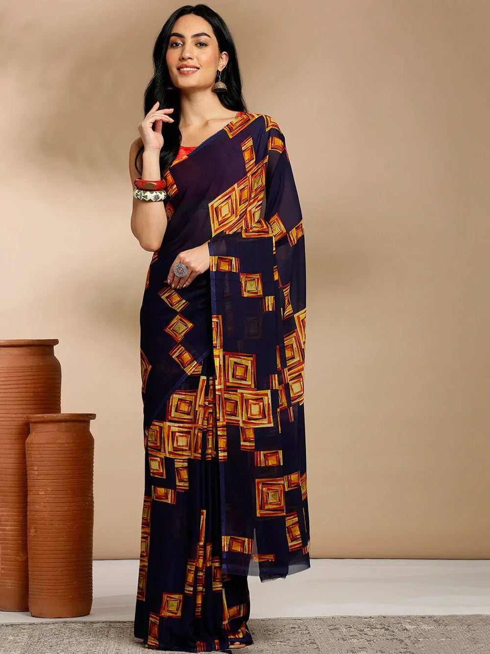 Navy Blue Geometric Printed Pure Georgette SareeSareeThis saree features a geometric print pattern, making it suitable for daily wear with its versatile and contemporary design. The absence of a border gives it a cleanNavy Blue Geometric Printed Pure Georgette Saree