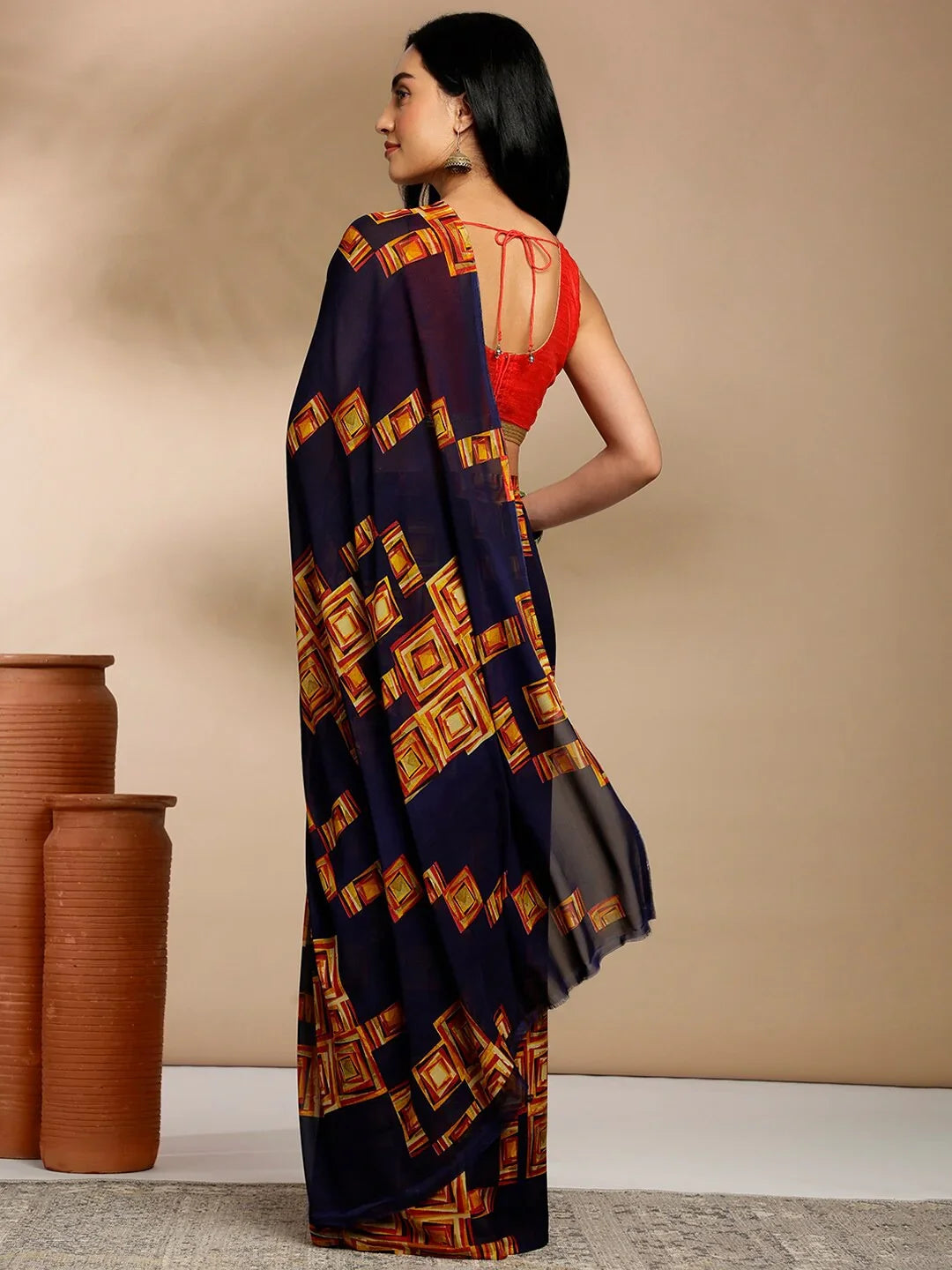 Navy Blue Geometric Printed Pure Georgette SareeSareeThis saree features a geometric print pattern, making it suitable for daily wear with its versatile and contemporary design. The absence of a border gives it a cleanNavy Blue Geometric Printed Pure Georgette Saree