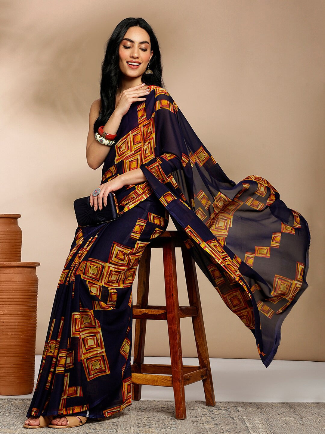 Navy Blue Geometric Printed Pure Georgette SareeSareeThis saree features a geometric print pattern, making it suitable for daily wear with its versatile and contemporary design. The absence of a border gives it a cleanNavy Blue Geometric Printed Pure Georgette Saree