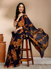 Navy Blue Geometric Printed Pure Georgette SareeSareeThis saree features a geometric print pattern, making it suitable for daily wear with its versatile and contemporary design. The absence of a border gives it a cleanNavy Blue Geometric Printed Pure Georgette Saree