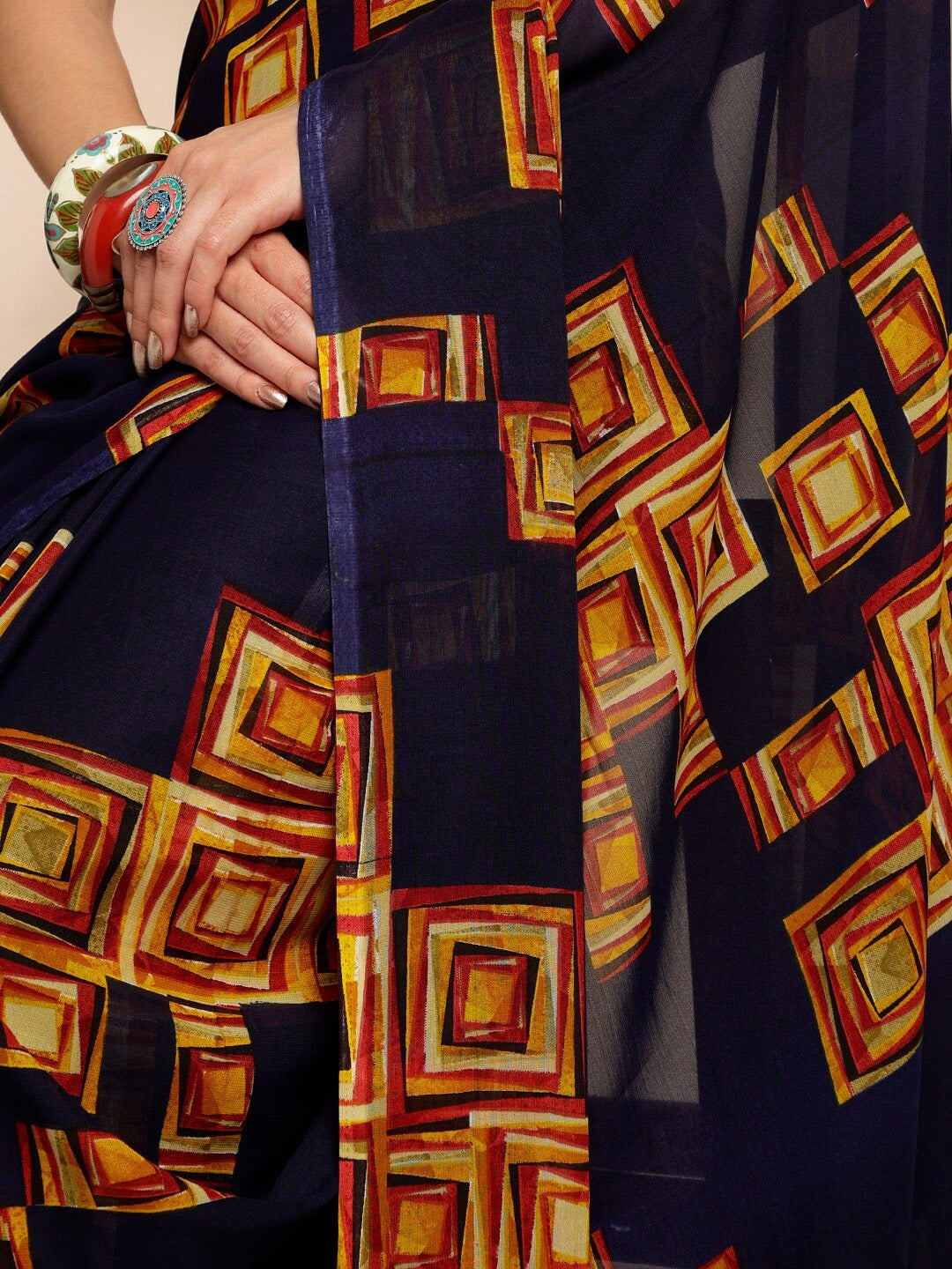 Navy Blue Geometric Printed Pure Georgette SareeSareeThis saree features a geometric print pattern, making it suitable for daily wear with its versatile and contemporary design. The absence of a border gives it a cleanNavy Blue Geometric Printed Pure Georgette Saree