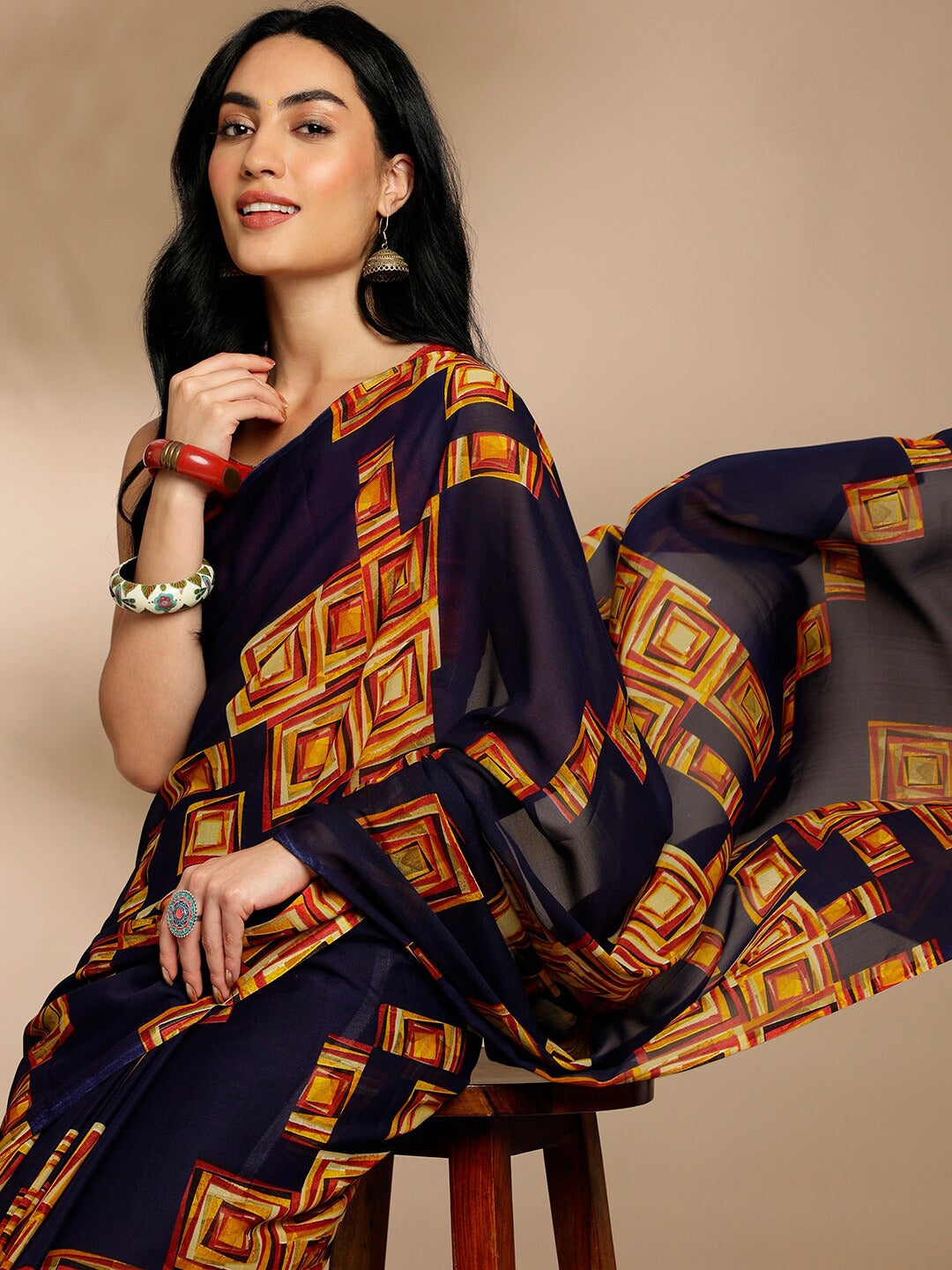 Navy Blue Geometric Printed Pure Georgette SareeSareeThis saree features a geometric print pattern, making it suitable for daily wear with its versatile and contemporary design. The absence of a border gives it a cleanNavy Blue Geometric Printed Pure Georgette Saree