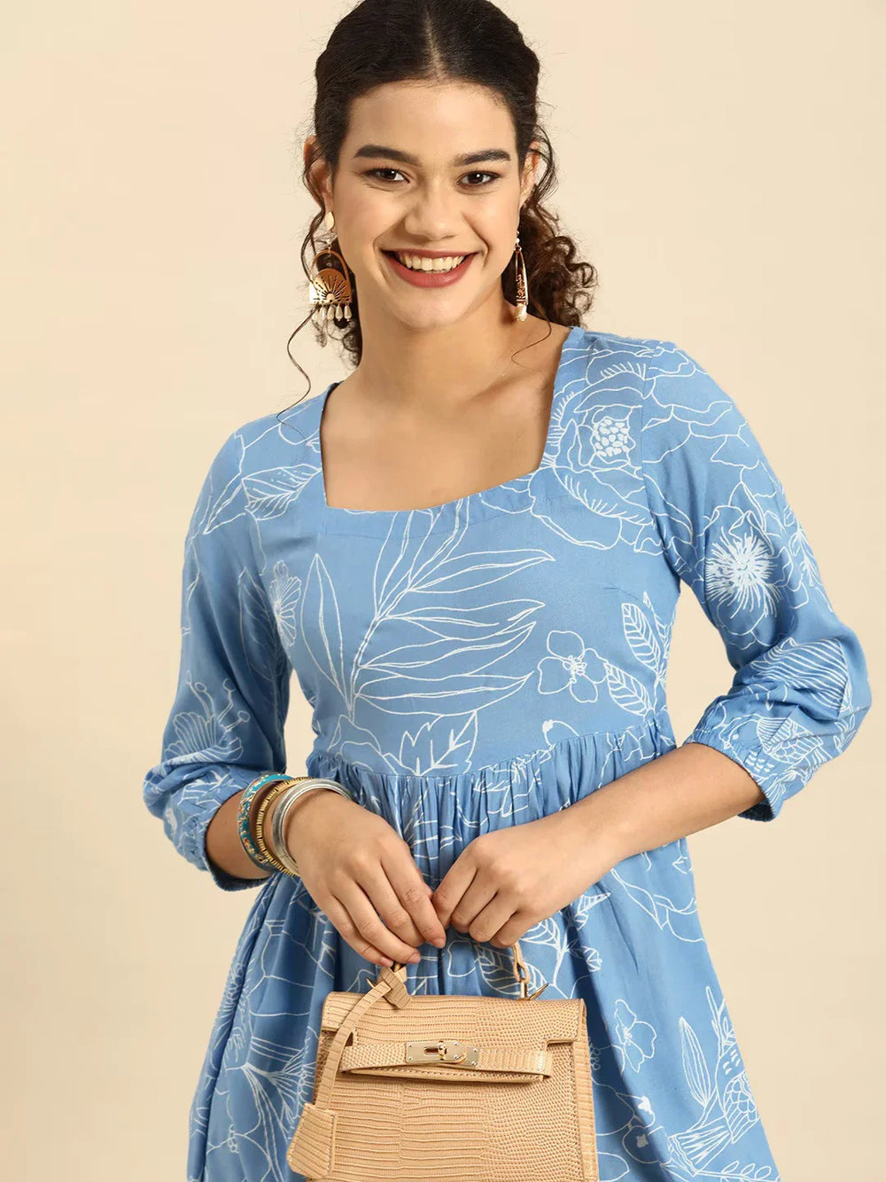 Blue & White Floral Square neck Fit N Flare DressEthnic DressesThis charming flared dress is crafted from soft cotton fabric, ensuring comfort and breathability for daily wear. Its flared hemline adds a playful and feminine toucBlue & White Floral Square neck Fit