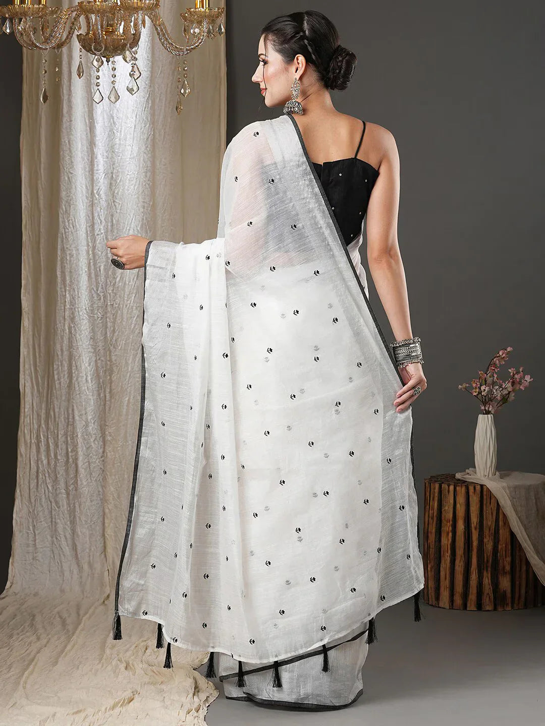 White & Black Floral Printed Zari Silk Cotton SareeSareeThis exquisite saree features a charming floral print, making it an ideal choice for festive occasions where vibrant elegance is celebrated. Adorned with intricate ZWhite & Black Floral Printed Zari Silk Cotton Saree