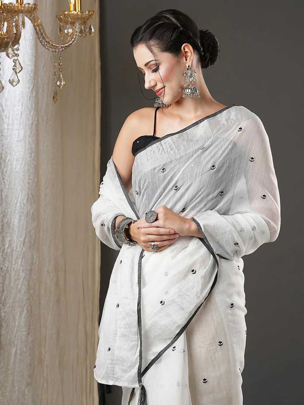 White & Black Floral Printed Zari Silk Cotton SareeSareeThis exquisite saree features a charming floral print, making it an ideal choice for festive occasions where vibrant elegance is celebrated. Adorned with intricate ZWhite & Black Floral Printed Zari Silk Cotton Saree